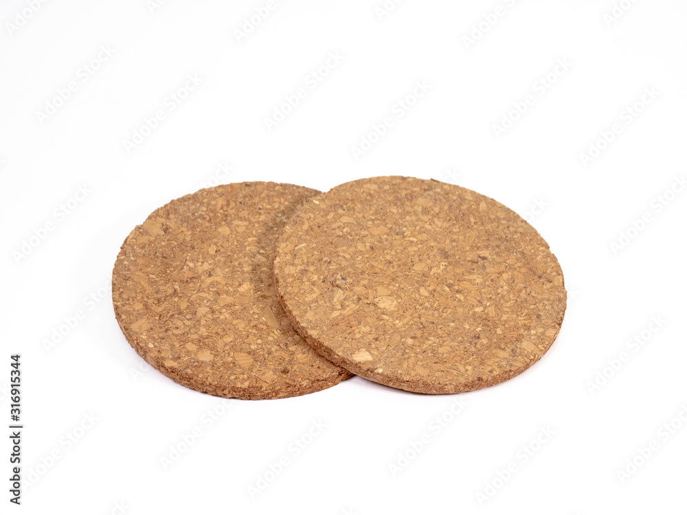 The close up of wooden cork coasters on white background. The close up of wooden cork coasters on white background.