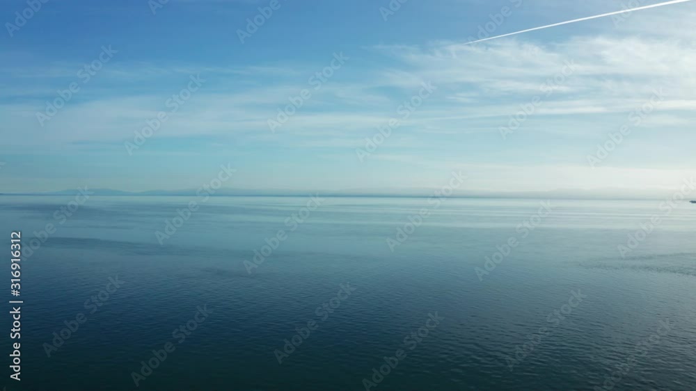 Perfect blue skies over the infinite waters of the bay on a sunny afternoon. Perfect blue skies over the infinite waters of the bay on a sunny afternoon.