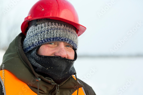 Portrait of a worker with a balaclava on his head
