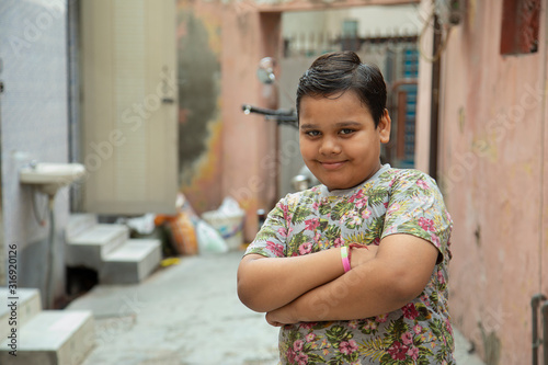 portrait of  a young boy standing in the varandah photo