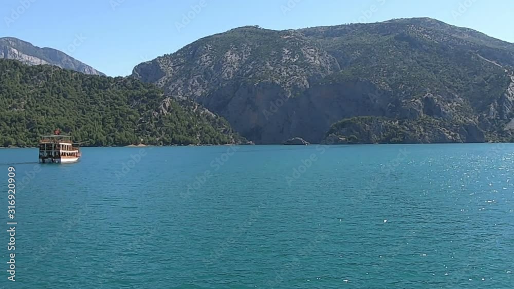 Wooden ship on the water of Green Canyon Wooden ship on the water of Green Canyon