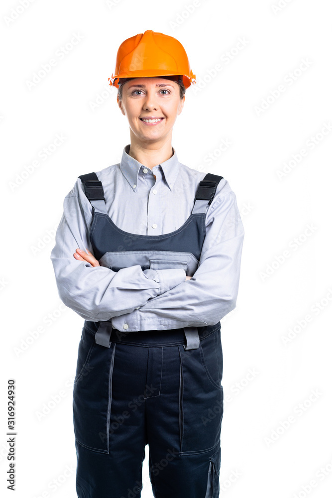 Toothy smiling business woman wearing a building helmet. Young girl. Isolated Toothy smiling business woman wearing a building helmet. Young girl. Isolated