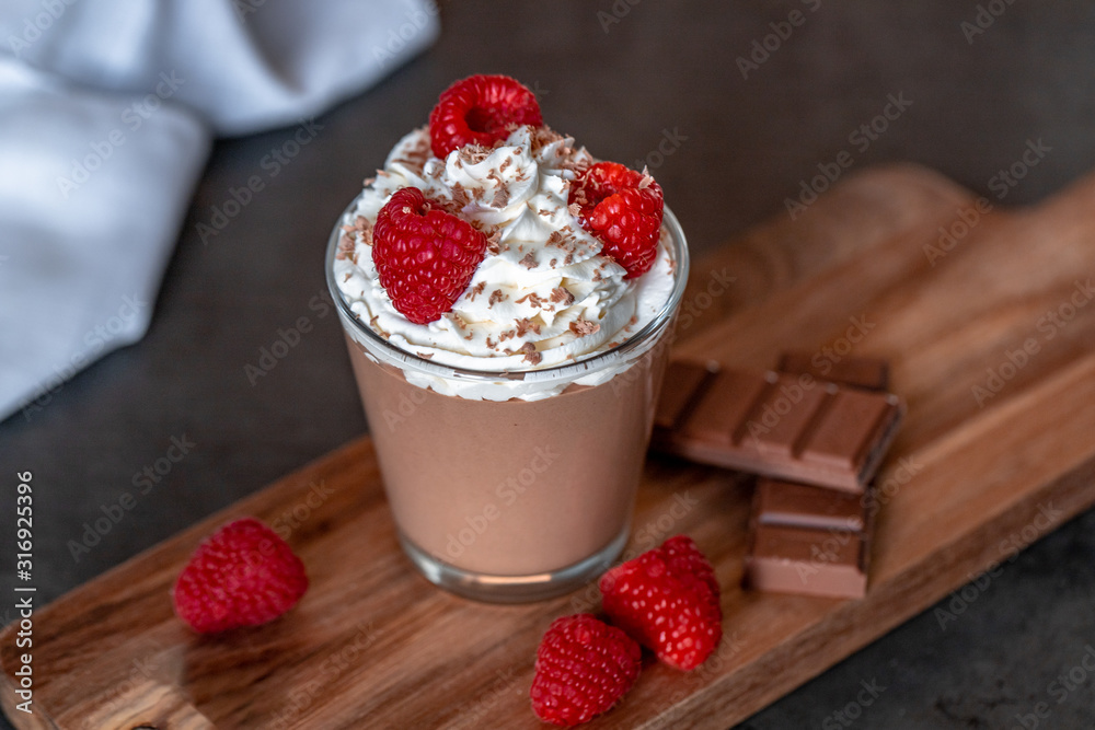 Homemade chocolate mousse with whipped cream, raspberries and chocolate shavings on top Homemade chocolate mousse with whipped cream, raspberries and chocolate shavings on top