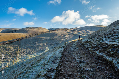 great Whernside from Kettlewell on a cold winters blue sky day with some snow and frost on the ground photo