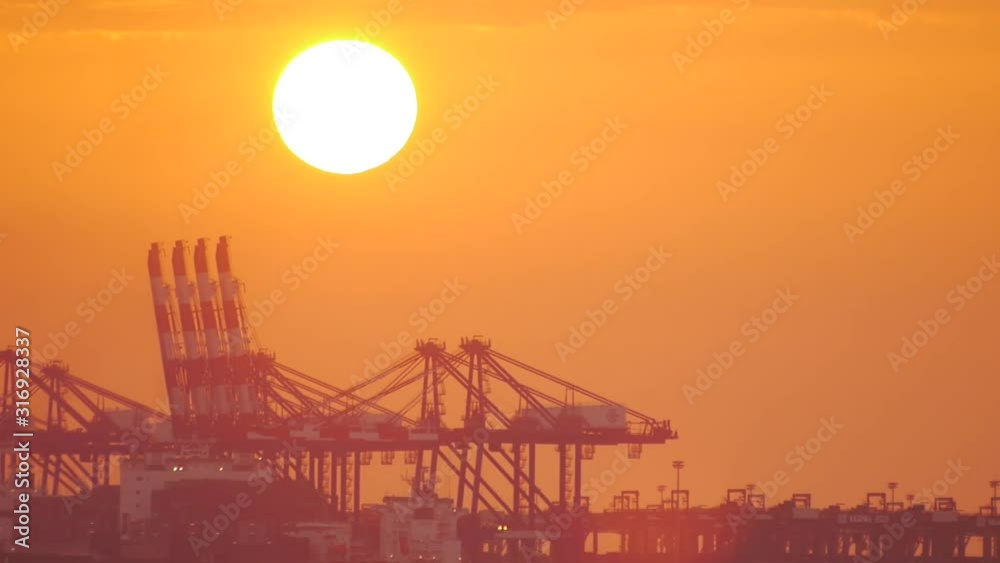 Sunset and cranes at cargo wharf Sunset and cranes at cargo wharf