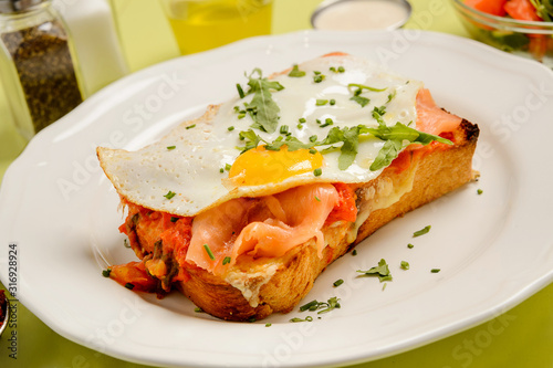 Delicious breakfast. Toast with salmon, egg and vegetables