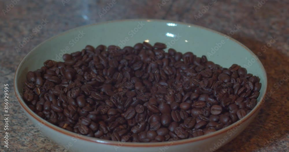 coffee beans being lifted and then dropped in slow motion. coffee beans being lifted and then dropped in slow motion.