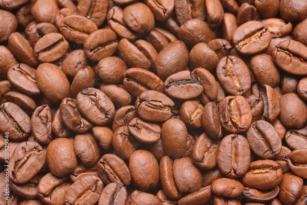 Background of roasted coffee beans photographed from above in close-up Background of roasted coffee beans photographed from above in close-up