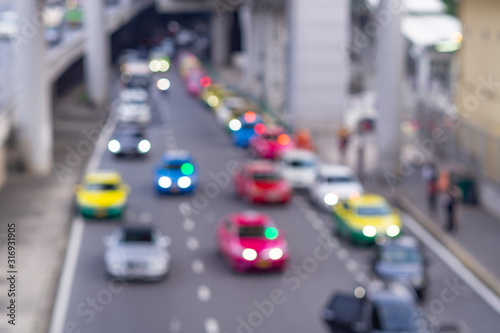 Evening city street in defocus for use as background. Blur focused urban abstract texture bokeh traffic jams.