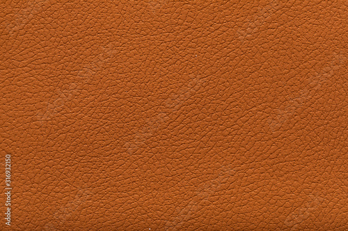 brown leather texture useful as orange background for design. High resolution photo