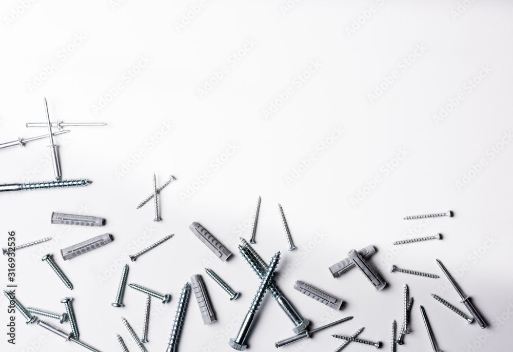 Screws and plugs of different kinds on a white background Screws and plugs of different kinds on a white background