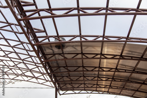 A worker mounts a metal canopy