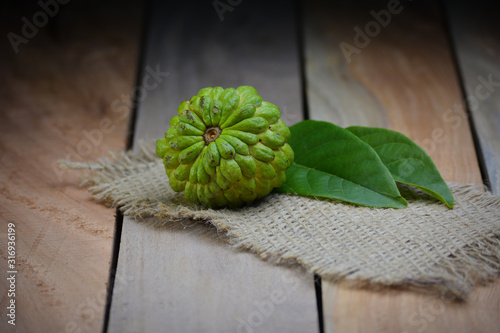 Fresh Custard Apple on wooden table background photo