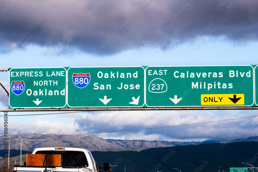 Highway 880 and Highway 237 interchange in South San Francisco Bay Area; Freeway signage providing information about the lanes going to Oakland and San Jose, California
