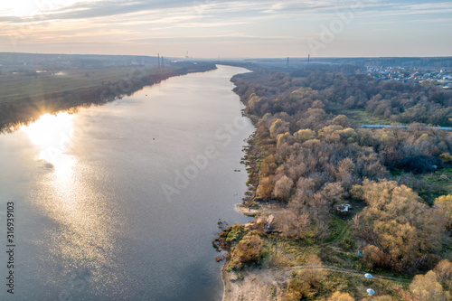 Bend of a wide river. Autumn landscape aerial view