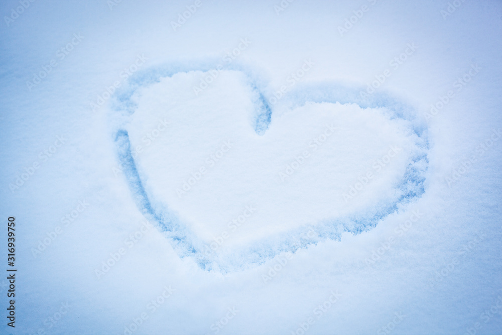 heart painted on fresh, fluffy, white snow,