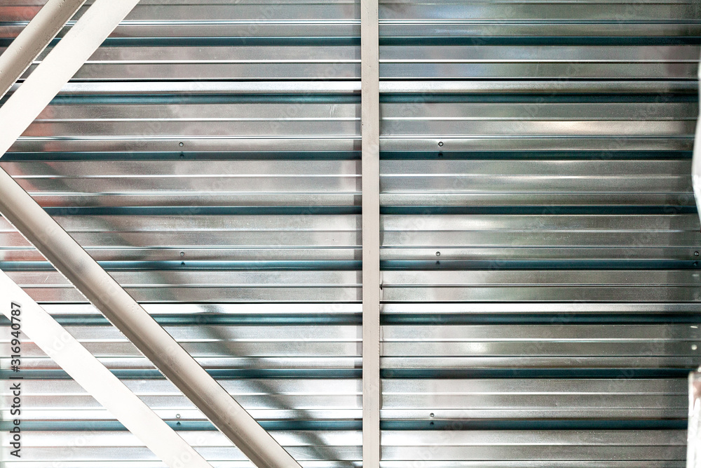 Gray corrugated metal sheet wall of industrial building Gray corrugated metal sheet wall of industrial building