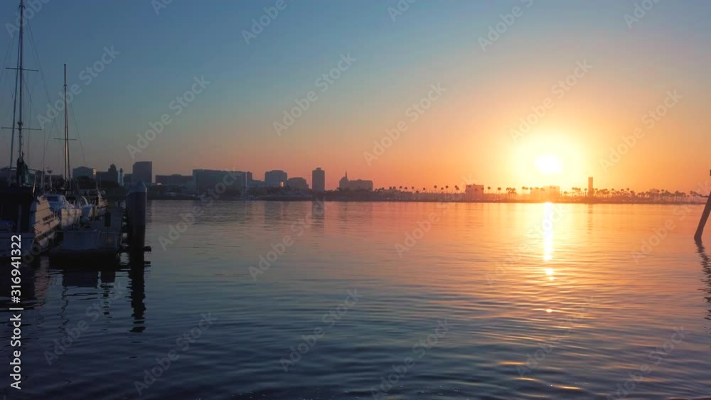 The sun setting behind the peaceful city of Long Beach, California - Wide shot The sun setting behind the peaceful city of Long Beach, California - Wide shot
