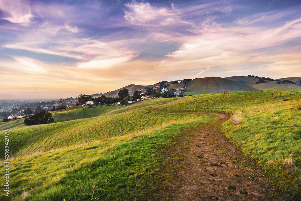 Sunset view of hiking trail on the verdant hills of East San Francisco Bay Area; California Sunset view of hiking trail on the verdant hills of East San Francisco Bay Area; California