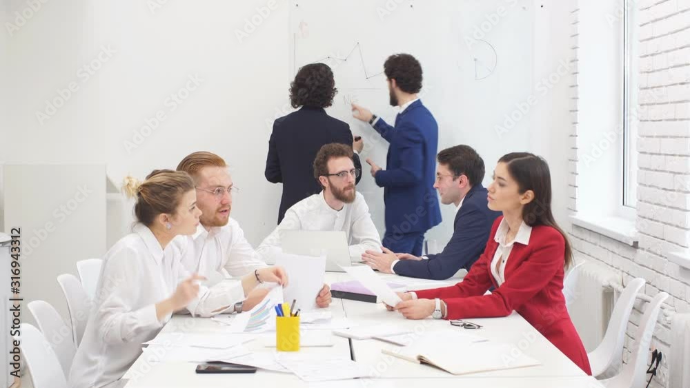 Best workers of successful busness team gathered in office to discuss new business project, to plan their strategy fot future together Best workers of successful busness team gathered in office to discuss new business project, to plan their strategy fot future together