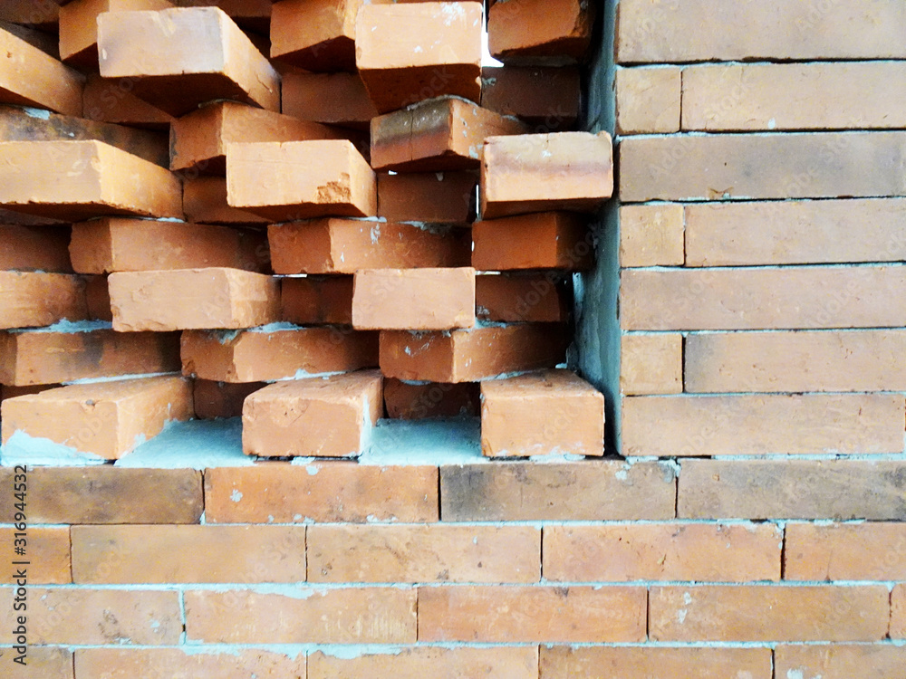 Fototapeta premium Wall made of red brick wall with unique composition