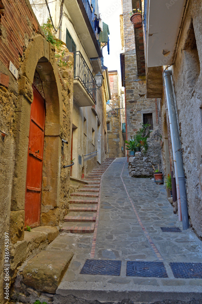 Altavilla Silentina, Italy, 10/21/2017. A narrow street between the old houses of a medieval village