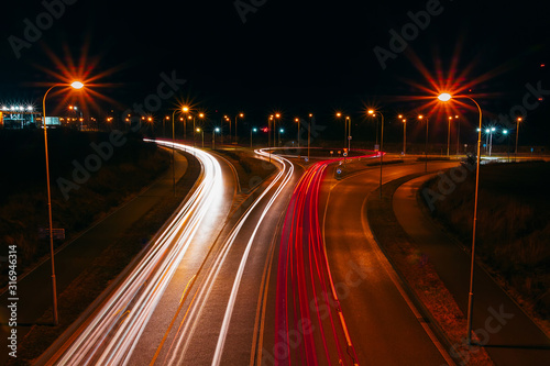 Light car trails on highway roundabout at night. Traffic long exposure photo, Ceské Budejovice, Czech republic
