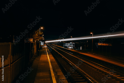 Light colorful train trails in station at night, aerial view. Traffic, travel long exposure photo