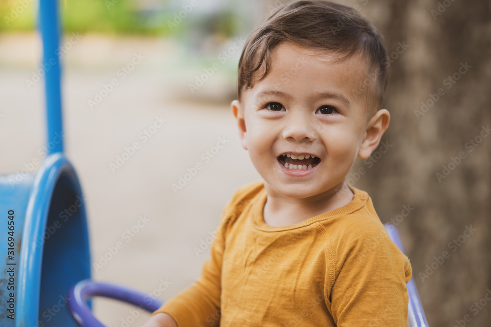 happy young boy playing outdoors in the park happy young boy playing outdoors in the park