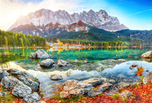 Faboulus autumn landscape of Eibsee Lake in front of Zugspitze summit under sunlight photo