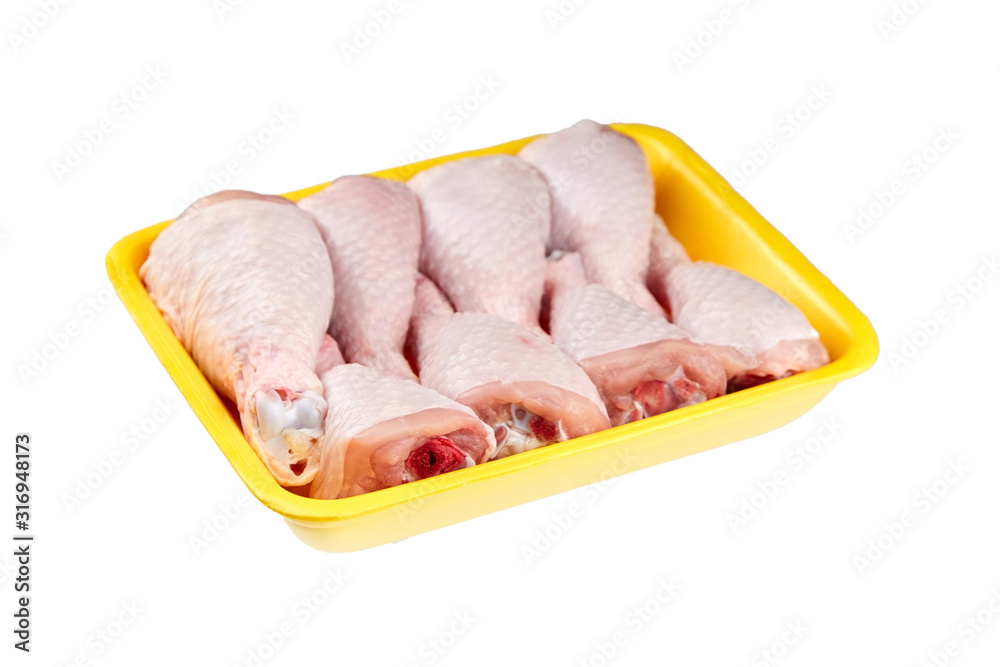 Chicken shin in yellow tray isolated on white background. Raw poultry meat Chicken shin in yellow tray isolated on white background. Raw poultry meat
