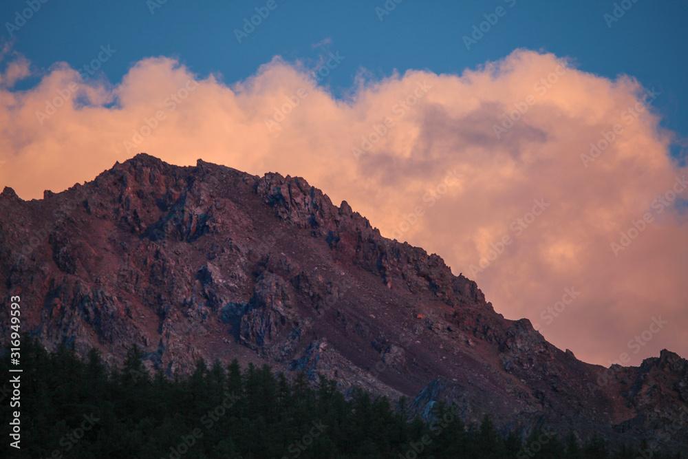 Bright sunset, rocky peak in red, natural backgrounds