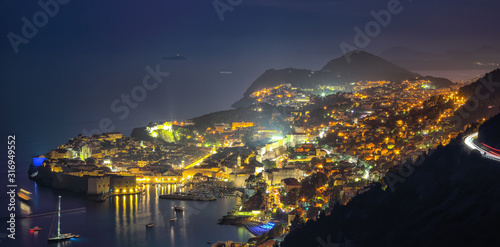 Aerial panoramic view of the old town of Dubrovnik in beautiful evening twilight at dusk.