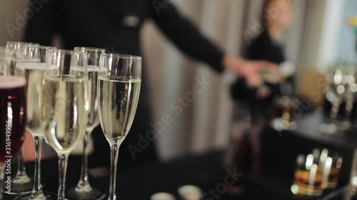 Barista pours cocktail into a glass
