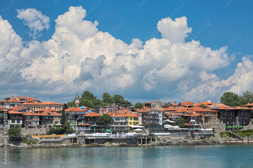 Sozopol Old Town (former ancient town of Apollonia) with Southern Fortress Wall and Tower, and beatiful cumulus clouds in the sky. Sozopol is the famous seaside resort on the Bulgarian Black Sea Coast