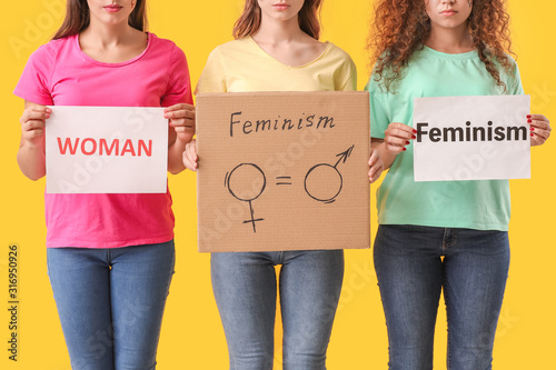 Young women on color backgr...