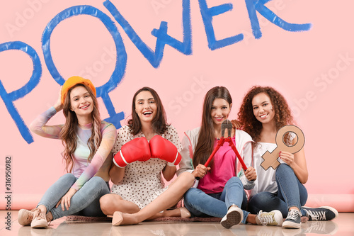 Young women near color wall...