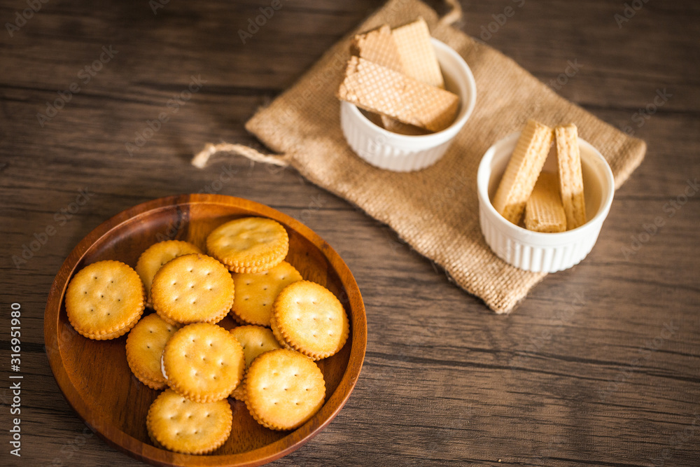 Dessert biscuit and cracker sweet food in coffee time put on the wood plate and wood table 