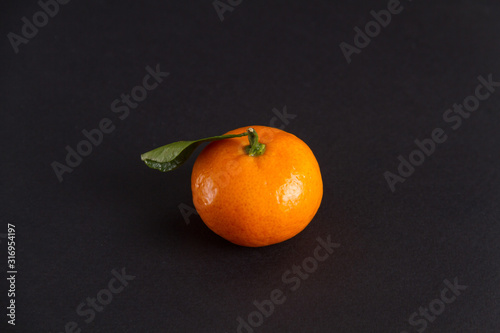 mandarin on a dark background with leaves