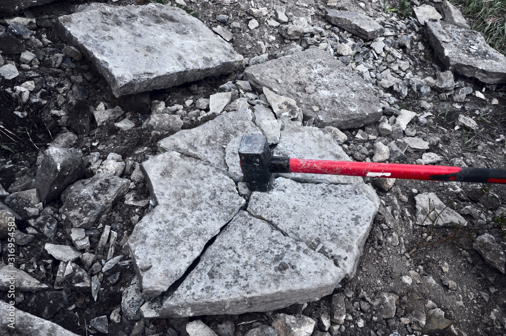 iron hammer breaking stone into pieces Stock Photo | Adobe Stock