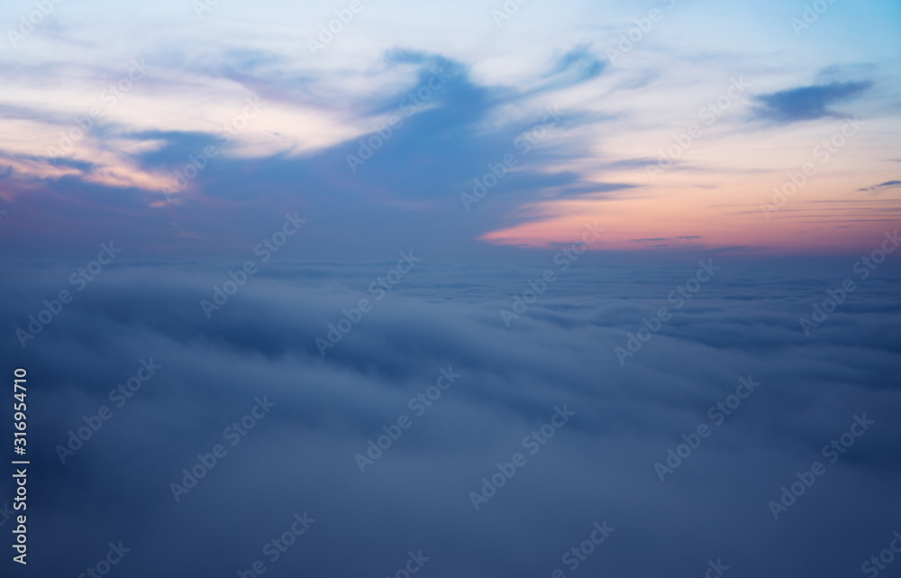 Beautiful aerial view from above clouds with sunset. Airplane view. Beautiful aerial view from above clouds with sunset. Airplane view.