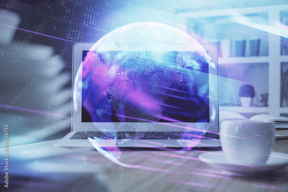 Computer on desktop in office with technology theme hologram. Multi exposure. Tech concept. Computer on desktop in office with technology theme hologram. Multi exposure. Tech concept.