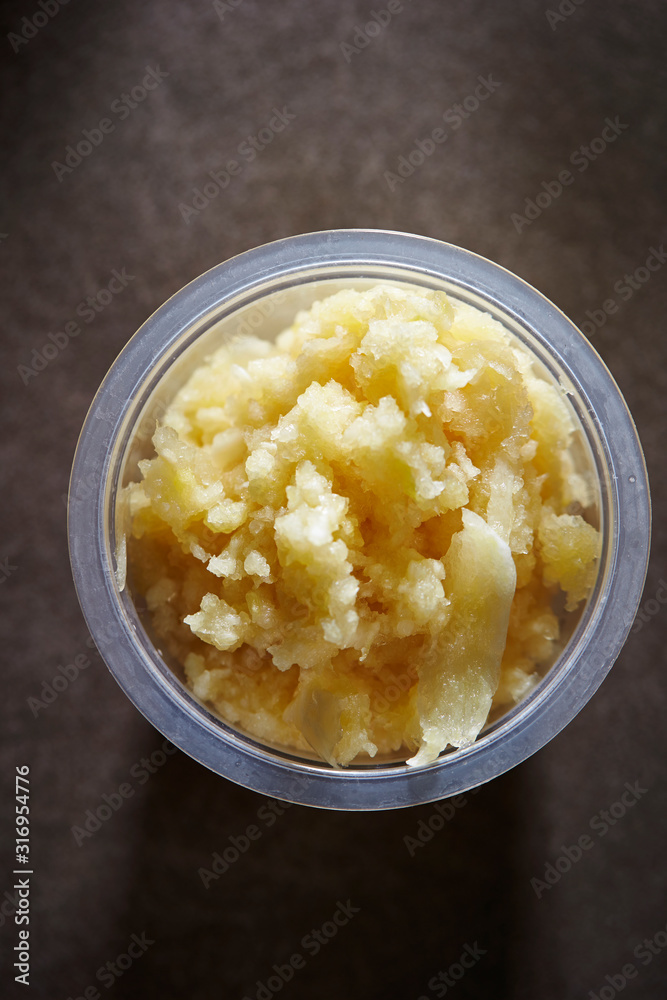 Crushed garlic in plastic bowl Crushed garlic in plastic bowl