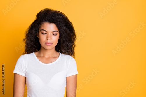 Photo of dreaming sleeping girl in white t-shirt near empty space focused on seeing nice dreams isolated vivid color background