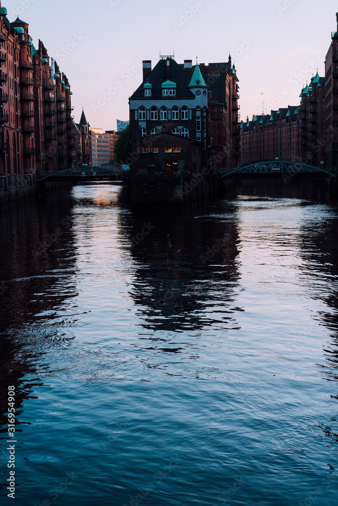 Silhouette of water castle in old Speicherstadt or Warehouse district in evening sun light, Hamburg, Germany