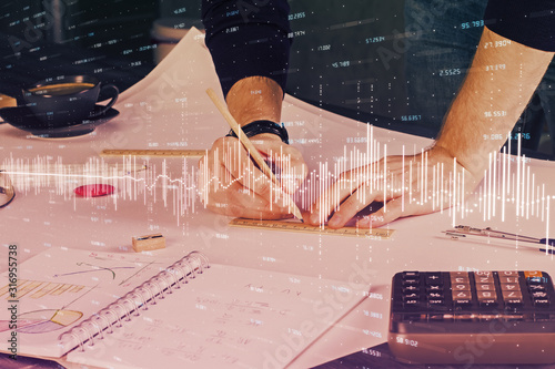 Double exposure of man writing on paper with forex graph.