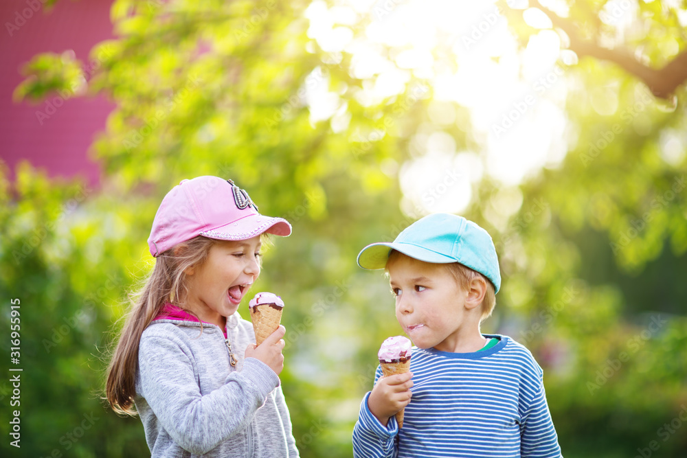 Happy child eating ice cream outdoors in summer Happy child eating ice cream outdoors in summer