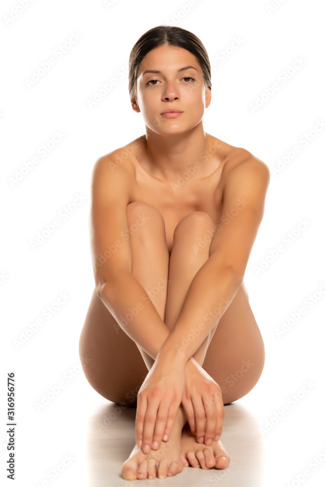 Obraz premium young seductive naked woman sitting on white