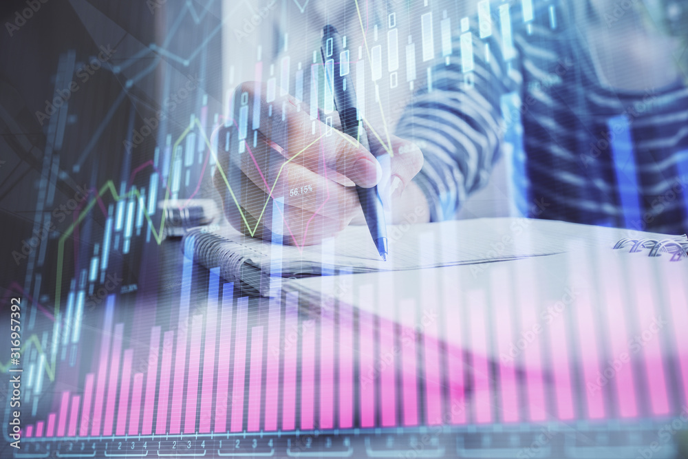 Financial forex graph drawn over hands taking notes background. Concept of research. Double exposure Financial forex graph drawn over hands taking notes background. Concept of research. Double exposure