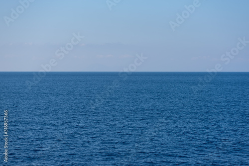 Sea and blue sky. Clean background. Horizon over water.